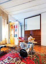 In one area of the apartment, Tagliabue’s son, Domenec, plays drums in front of a sliding wood panel of the architects’ design.