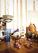 Resting atop an oak table by Miralles, amidst a collection of tchotchkes, is the “B” trophy awarded to the pair for their work on the Santa Caterina Market rehabilitation project. A Louis Poulsen lamp hangs just above.  Photo 10 of 23 in The Barcelona Home Like No Other
