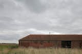Long and low, the Ochre Barn began its life as a threshing barn in the 1850s.