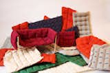 Here the original model rests on a pile of other covers, stitched in her studio by her employees. "It took many trials on the sewing machine to find a more interesting quilting stitching than simple squares," she says.  Photo 6 of 14 in Designing the Ruche Sofa by Jaime Gillin