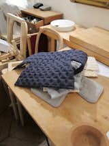 "Here it began to be better," she says, pointing out the new "interrupted" stitch line. "We tried many kinds of interruption, but here was the a-ha moment. I thought 'ok, let's try'." This blue cover was created to-scale, to be affixed to a 1.5-scale mockup.