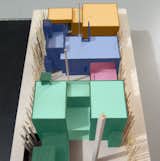 The City would not accept a design where the front part of the house, shown in green, is physically disconnected from a back part of the house, shown in blue. It was acceptable for the garage and recreation room, shown in yellow, to be detached from the blue structure. We argued that the raised swimming pool deck, marked in red, which is physically attached to the green and blue structures, should constitute a sufficient "connection" between the front and back parts of the house. This City did not agree. So as much as we like our internal courtyard, we need to make a stronger physical connection between the green and blue structures if we are to receive our building permit.