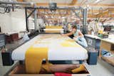 A seamstress mans the automated Gerber Cutter, which cuts patterns precisely and in a way that minimizes wasted fabric.  Photo 7 of 11 in Ruché Sofa