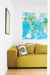 A mustardy couch and a large map of the world—Whitlock travels all over the place for work—keep the living room bright and cheerful.
