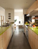 Here's another instance of a bit of bright color (on the countertops) giving an appealing accent to what is an otherwise pretty sedate palette. And if affordability is the name of the game, often a splash of color is more achievable than a spendy material.