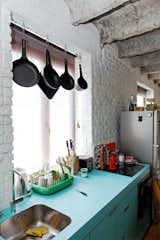 A green Dish Doctor by Marc Newson for Magis adds just a bit more color to the blue facing of the kitchen sink and cabinets.  Photo 3 of 3 in Small Spaces by Simon M. Hurdon from A Little Apartment Gets a Solid Renovation