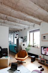 In the architect's own home in Bratislava, Lukáš Kordík took advantage of his 1930s apartment's undulating, raw-concrete ceiling by exposing it. Contrasting with pops of color throughout the apartment, the structural vaults provide textures and an industrial flair to create a unique space.