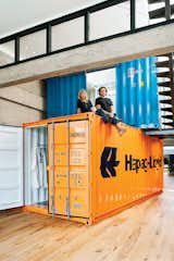 Their solution was to stack two shipping containers on top of each other, to create private space within the open-plan living area.