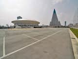Here's the Ryugyong Jong Ju Yong Indoor Stadium that seats 12,000. The pyramidal structure just beyond it is the Ryugyong Hotel.  Photo 3 of 5 in An Architecture Guide to Pyongyang by Aaron Britt