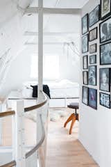 Bedroom The snug attic in this former fisherman’s cottage in Copenhagen contains the homeowner’s platform bed, custom-designed by Jonas Bjerre-Poulsen to maximize storage and fit the unusual space.  Photo 11 of 11 in Make Your Space Look Bigger: 10 Lofted Bedrooms from Light-Filled Family Home Renovation in Copenhagen