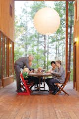 Dining Room, Chair, Table, and Pendant Lighting The large wraparound porch links the two main houses and two guest cabins, and is the site of many impromptu shared meals.  Photo 1 of 14 in Four Friends Joined Forces to Realize This Idyllic Forest Retreat Outside Toronto