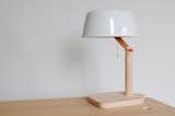 Studio Gorm's Peg light has a wooden base and porcelain shade and is reminiscent of an old library lamp.