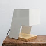 THINKK Studio, based in Bangkok, Thailand, created the Foldo lamp out of powder-coated folded steel and a wooden base. It looks great on a desk. Bonus: you can attach photos and notes to the shade with magnets.
