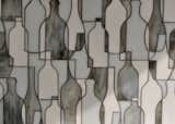 A longtime tile designer, Erin Adams began to work on a collection for New Ravenna in 2011. She seeks to develop patterns not usually seen in tile, like her abstract "Bottles" design.