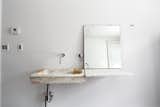 In the guest bathroom, Givone installed a hand-chiseled sink made of 17th-century marble quarried from the hills outside of Rome.