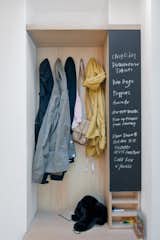 A built-in closet and chalkboard surface in the entry keeps things tidy and the couple's to-do list in order.