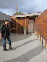 Beckmann stands in front of one of the four Lautner-designed units, each of which opens onto the concrete walkway and have a private entrance and private patio (set behind the redwood fence to the left).