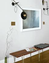 Workstead wall-mounted lamps illuminate a photo from Cloud Series by Matthew Williams. The bench is by Hugh Acton.