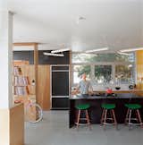 Riffing on the Los Angeles phenomenon of people "murdering out" their cars—that is, removing all the trim and blacking everything out—architect Barbara Bestor and craftsman Eric Lamers covered most surfaces in this Los Angeles kitchen with matte black laminate, including the fridge and the overhead cabinets.