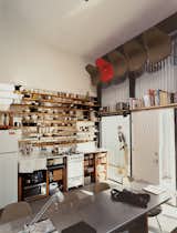In a 15.5 by 20-foot studio apartment, space is at a premium, to put it lightly. The resident, a designer, sized his kitchen shelves to accommodate specific kitchen gear: narrowest at the bottom for spice jars and juice glasses and widest at the top for plates and cookware. The most frequently used objects are all within arm's reach. The small fridge and Tappan stove are perfectly adequate as long as you "get a little smarter with your yogurt layout," says the resident. See the full slideshow here.