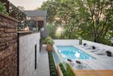 The architects sited the patio and swimming pool beneath a canopy of mature maple trees, an element that they say makes the site "an oasis in the heart of the city."