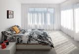 In the master bedroom, a Mandal bed from Ikea is draped with a Tuuli duvet cover by Marimekko.