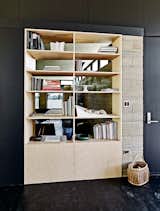 A birch-ply bookcase, designed by Juliet Hsu with input from Wright, stands in the living room and is one of several custom furnishings.  Photo 5 of 10 in Ingenious New Building Method Replaces Concrete Block with Rammed Earth