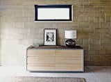 The earth bricks are a dominant visual element in the master suite, which is furnished with a dresser from Room & Board.  Photo 6 of 10 in Ingenious New Building Method Replaces Concrete Block with Rammed Earth