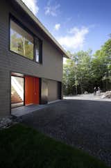 An orange front door add a bold splash of color to the otherwise monochromatic exterior.  Search “quebec” from House Inspiration