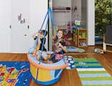 In their bedroom, Anya and Yash hang out in the boat-shaped swing by Haba that their aunt brought them from Germany (it’s not currently available in the United States). A Rapson Rapid Rocker by Rapson-Inc. sits next to the window.