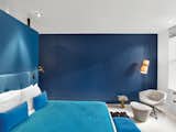 The artists used Old Navy paint from Benjamin Moore to give this guest room a blue hue.