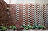 The wall surrounding Ravi and Esha Chowdhary’s backyard in Bangalore, India, includes bricks made from soil that was excavated for their home’s foundation.
