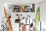 Designer and digital fabricator Shawn Benson shares his 595-square-foot second-floor space with his wife, Jessica, and their daughter, Roux. The 15-foot-high ceilings allow plenty of room for a full-size ocean paddleboard.