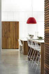 Kitchen, Concrete Floor, Pendant Lighting, and Wood Cabinet The floors in the kitchen are polished concrete.  Search “Alessis Fall Winter Collection” from A Modern Home For a Design-Savvy Family in Florida