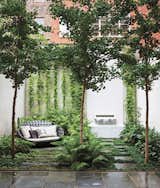A thoughtfully designed garden in New York City makes way for an existing fountain by landscaping vertically around it. The water feature includes an Italian marble spout designed by Thomas Woltz.