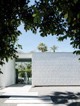 Home with white facade made of textured ceramic tiles