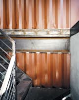 shipping container home staircase with industrial metal tread and railing