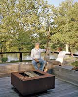 The staggering of the shipping containers created a series of decks in the rear of the home, which overlooks the Delaware River. A mix of vintage finds and pieces designed by Mathesius, including a Cor-Ten steel fire pit on the second-floor deck, furnish a majority of the home.