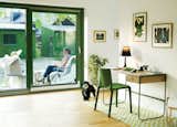 Franson Wreland also designed the court-yard and a pair of 160-square-foot outbuildings—one is used as guest quarters and the other as storage space. While residents Julia and Fatima Olivero-Reinius chat outdoors, Chippie the dog approaches an Asplund desk and a chair by LucidiPevere.