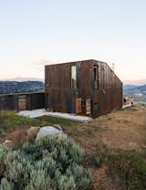 Using a limited material palette helped architect Jesse Garlick save on the bottom line when building his off-the-grid vacation home in Washington state. The entire facade is sheathed in Cor-Ten steel, which will patina into a hue that mimics the local bedrock.