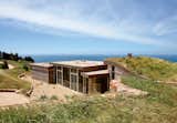 “I’ve been all around the world, and whenever I come back here, I realize that the Pacific Ocean seen from those cliffs is the most beautiful view on earth,” says the resident of this house built into a hillside in Big Sur, California.