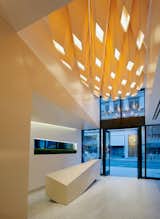 Construction did involve something of a sleight of hand: the coffers are made without any mechanical fasteners like screws, but held in place by folding and gluing the material onto itself. When the ceiling is “on,” it emits a luminous glow.