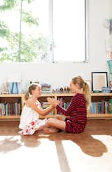Daughters Ingrid and Jane play on the floor of their bedroom, laid with reclaimed end-grain parquet from Oregon Lumber.  Photo 9 of 21 in L-Shaped Indoor-Outdoor LA Home