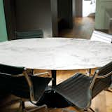 Calder Smith uses his elliptical table, designed in 1956 by Eero Saarinen for Knoll, as a place for both dining and working. “It’s not as heavy as you might think, so it’s easy to move around,” says the architect. “Plus the base allows room for lots of legs—we’ve had up to eight people sitting around it at one time.”  Photo 13 of 14 in High-Rise Living in Manhattan