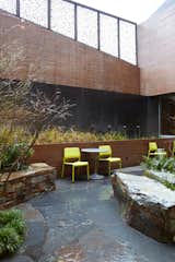 The landscaped courtyard—which features seating, tables, and a bioswale—provides a sheltered place for people to wait for services. Photo by Chris Mueller.  Photo 2 of 9 in Commons' Grounds