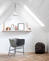 Crisp white walls contrast with the surface of the painted white boards of the ceiling, keeping the interiors modern and clean.