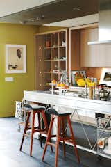 Kitchen and Metal Counter The kitchen takes on a gallery feel. “I’ve got art on the kitchen counter. I really want to say to people, ‘Don’t take art so seriously,’” says Montague.  Photo 1 of 20 in Modern Kitchens We Love by Sara Ost from Party-Friendly Apartment in Toronto