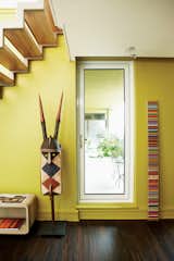 In the library, Douglas Coupland’s Spectra sculpture sits next to a century-old helmet mask from Burkina Faso.  Photo 8 of 15 in My House: A Toronto Dentist-Curator-Collector Creates a Sophisticated Yet Party-Ready Penthouse
