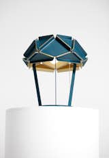 The Karat lamp (2011) is made from folded sheets of anodized and varnished aluminum connected with glass plates that allow diffused light to shine though the seams. While we've seen a flurry of geometrically-inclined and brass-hued pieces recently, we can't help but admire the complex construction of the shade.