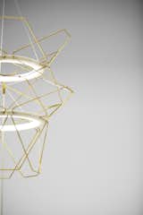 The LED-illuminated Astral lamp (2010) is part kinetic sculpture, part pendant light. The two rings containing the bulbs can be brought closer together, or moved further apart.